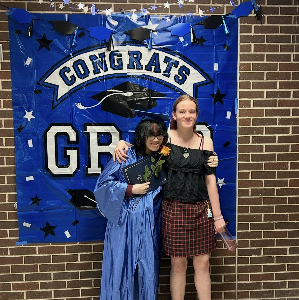 Taylor at graduation with friend